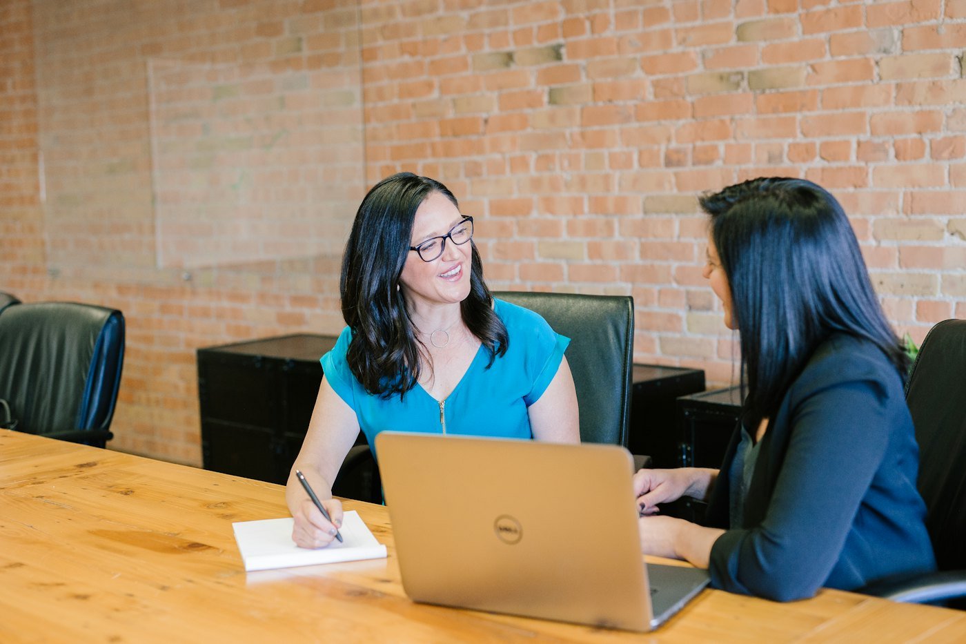 Two professionals in conversation during a client consultation