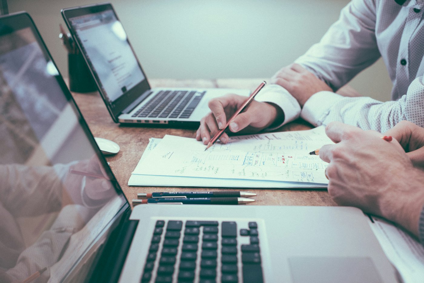 Accountant reviewing figures on a laptop with a pencil in hand