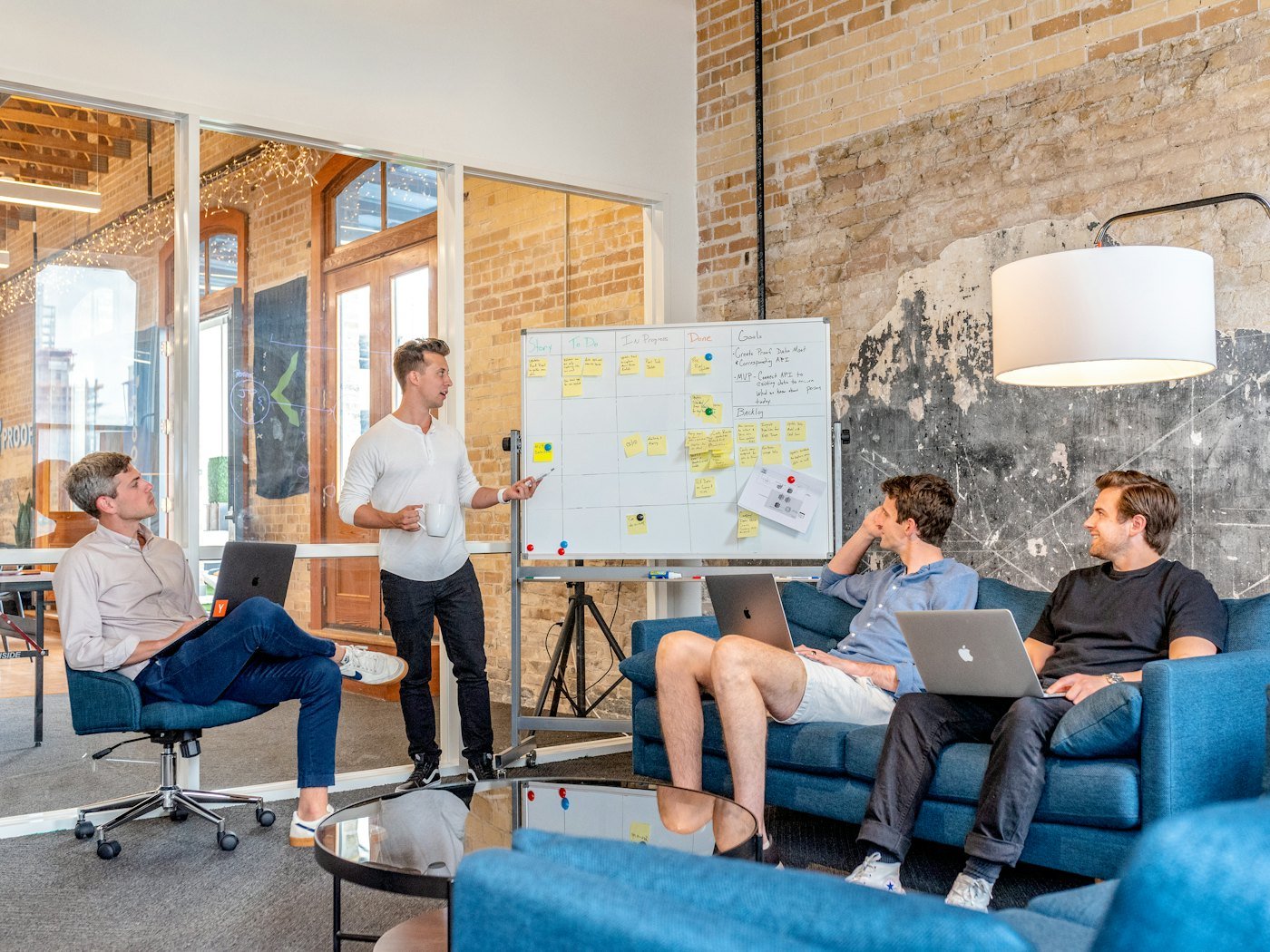 Colleagues using laptops beside a whiteboard